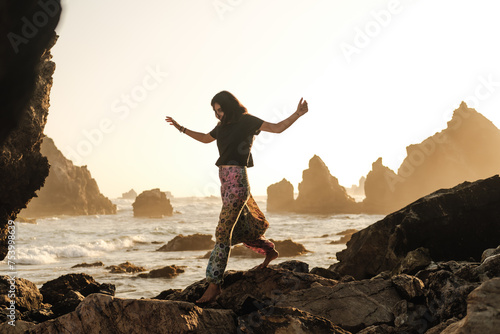 carefree woman walking on the beach photo