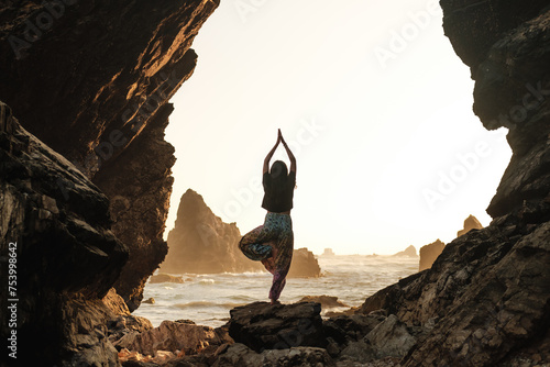 Silhouette of woman doing yoga in nature photo