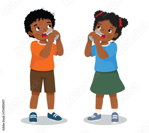 Cute little African boy and girl drinking a glass of water together
