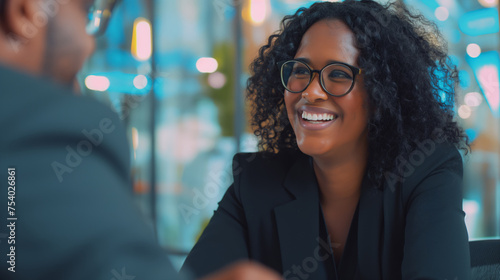 Radiant Black Woman Laughing with Curly Hair and Glasses at office