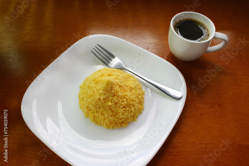 Brazilian breakfast. Coffee cup with corn couscous traditional in morning in Brazil.