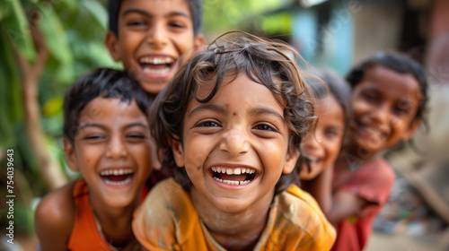 Group of Indian villager kids, smiling and laughing in a group. Looking at the camera. photo