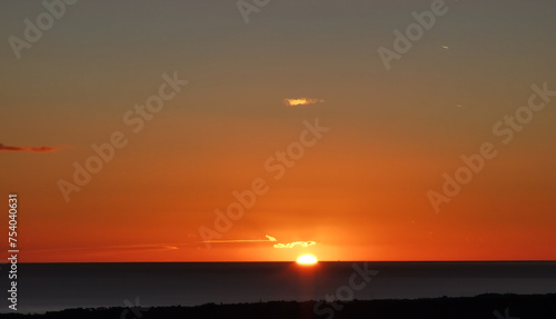 Il Sole accecante che all’alba sorge dal mare visto da sopra le colline  © GjGj
