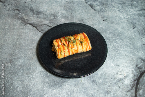 Chicken puff roll served in plate isolated on background top view of baked food indian dessert