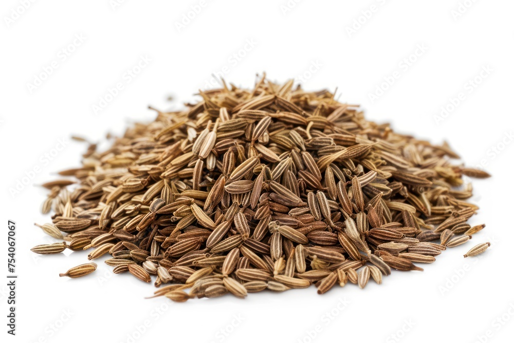 A pile of cumin with a white background. The seeds are brown and scattered. Concept of abundance and variety A pile of cumin with a white background. The seeds are brown and scattered. Concept of abundance and variety
