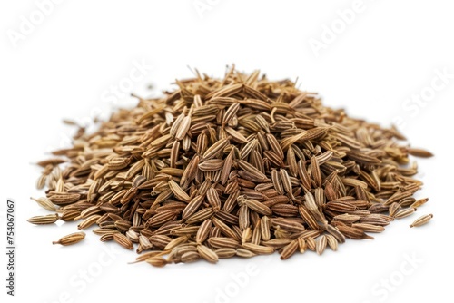 A pile of cumin with a white background. The seeds are brown and scattered. Concept of abundance and variety