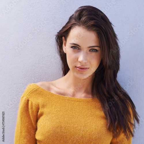 Portrait  fashion and confidence of woman on a wall  model or girl isolated on a purple background. Face  serious and beauty of young person in casual clothes  trendy and stylish sweater in Italy