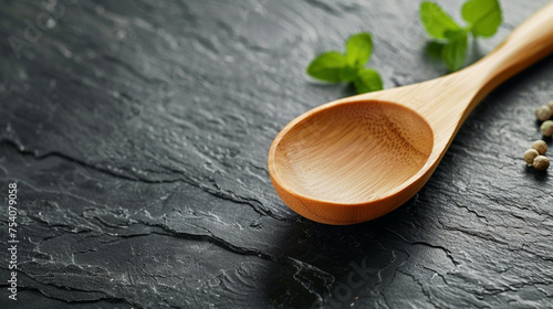 Directly bottom view shot of wooden spoon on dark surface table in a kitchen photo