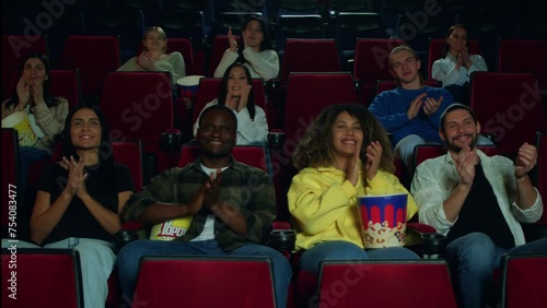 It is a blast. The audience applauds after watching the premiere of a new film, the audience applauds at the cinema, the audience is delighted with the new film and applauds at the cinema.