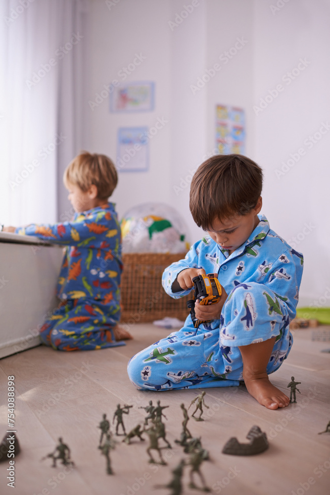 Boys, toys and young children in pajamas playing for fun with action figures, car or games. Brothers, child development and young kids bonding together in playroom for learning at family home. Boys, toys and young children in pajamas playing for fun with action figures, car or games. Brothers, child development and young kids bonding together in playroom for learning at family home.