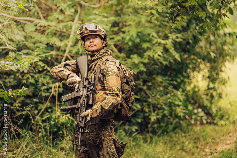 SEALs from the Army are frontline soldiers ready to fight and check on enemies on the battlefield. They wear military uniforms, have M16 rifles, helmets, and vision goggles. The terrain is forest.