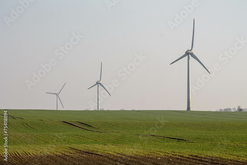 three windmills in a field