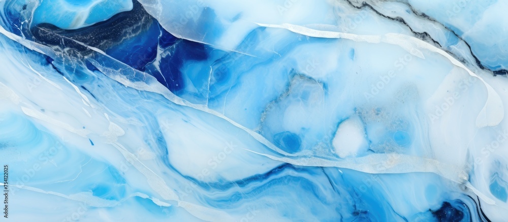 Obraz premium Close up view of a luxurious blue and white marble texture showcasing the polished surface of the natural stone.