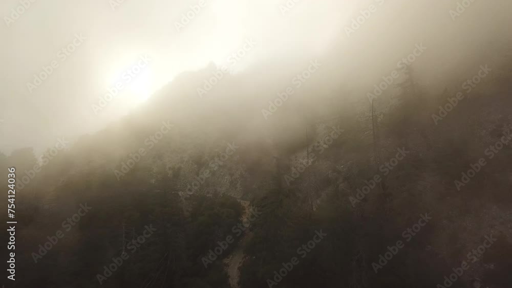 Foggy sunset view of Mt. Lowe on the Eaton Saddle Trail in the San Gabriel Mountains of Mount Wilson, California, USA. Foggy sunset view of Mt. Lowe on the Eaton Saddle Trail in the San Gabriel Mountains of Mount Wilson, California, USA.
