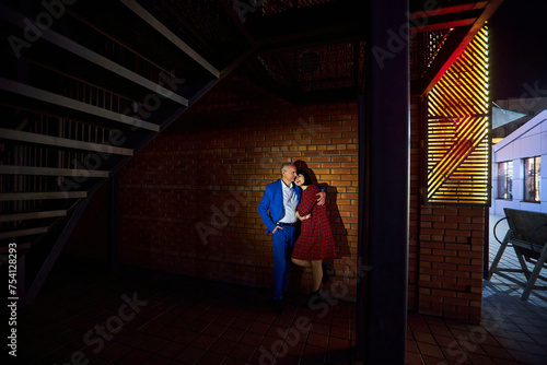 A beautiful adult married couple on a walk in the night city. © Fotoproff