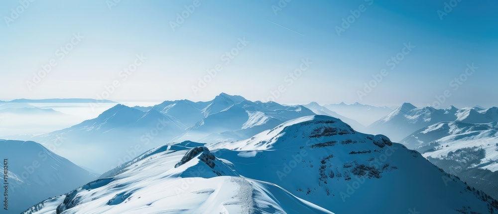 Serene Snow-Capped Peaks Under Clear Blue Sky