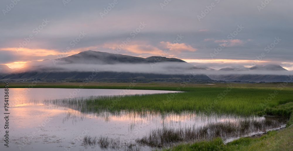 Colorful sunset, lake and scenic landscape of Icelandic countryside