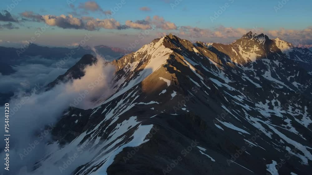 Enticing snowy mountains shrouded in cloudy sky pristine nature drone view Enticing snowy mountains unparalleled northern beauty rugged slopes. Enticing snowy mountains Earth's primeval allure. Enticing snowy mountains shrouded in cloudy sky pristine nature drone view Enticing snowy mountains unparalleled northern beauty rugged slopes. Enticing snowy mountains Earth's primeval allure.
