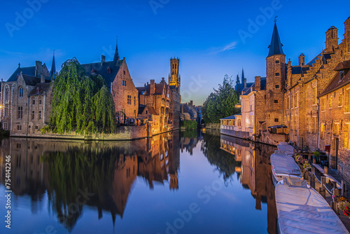 Evening atmosphere in the old town of Bruges. Canal of the Rosary Quay in the Hanseatic city. Reflection on the water surface of the historic buildings with tower belfry