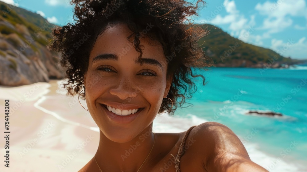 Smiling young woman enjoying tropical beach vacation, with picturesque ocean and lush hills in background. Happiness and travel.