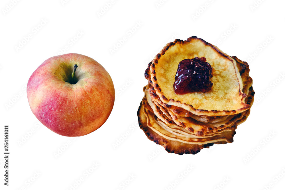 A red apple lies next to the pancakes, isolated on a white background A red apple lies next to the pancakes, isolated on a white background