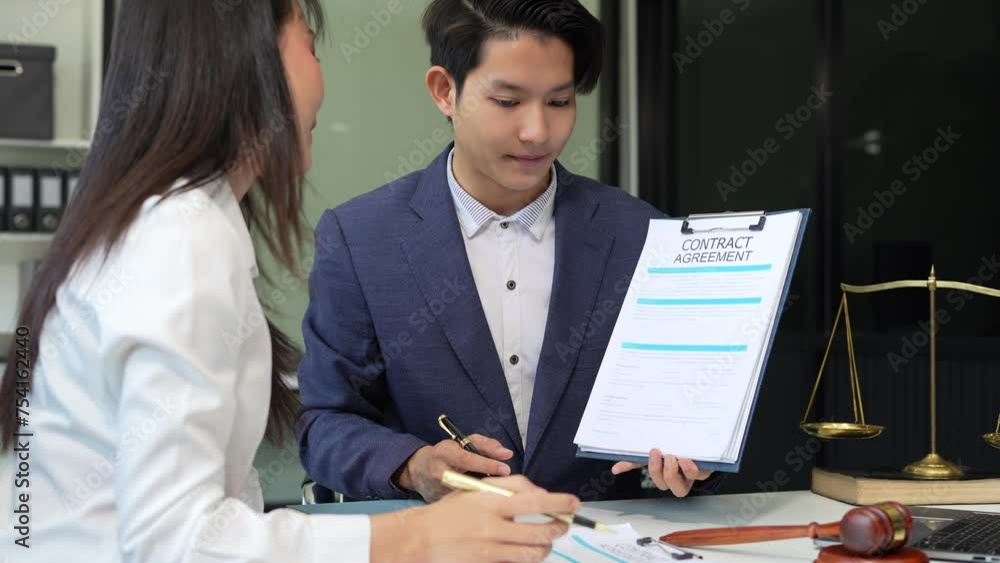 Business people and lawyers discussing contract papers sitting in the table at office in the morning. concepts of law, advice, legal services. Business people and lawyers discussing contract papers sitting in the table at office in the morning. concepts of law, advice, legal services.