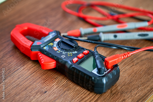 A screwdriver lies on a multimeter measuring device