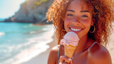 Beautiful smiling young woman eating an ice cream on a beach with the sea in the background