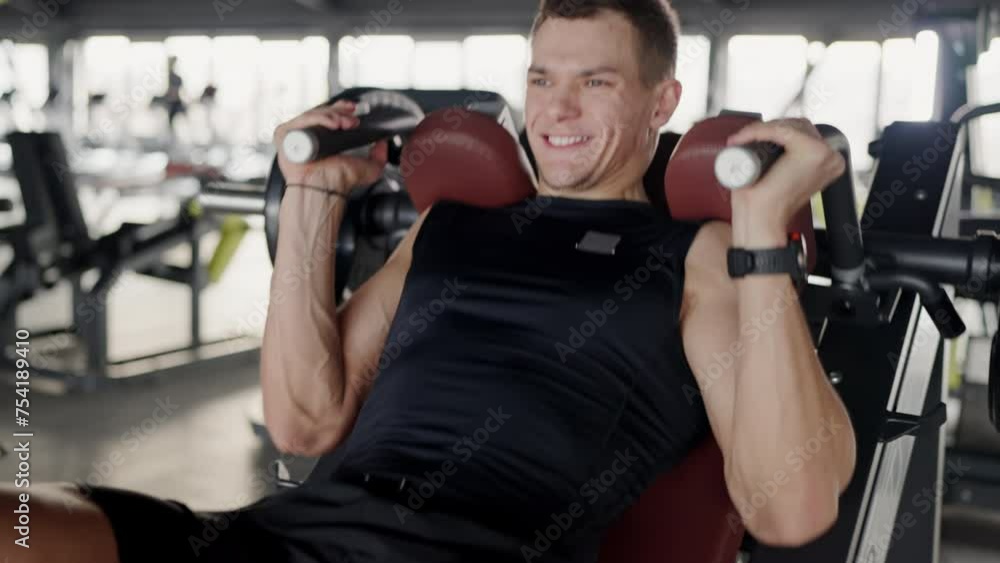 A man is using sports equipment to lift a dumbbell at the gym, working on his arm, shoulder, chest, and muscle strength A man is using sports equipment to lift a dumbbell at the gym, working on his arm, shoulder, chest, and muscle strength