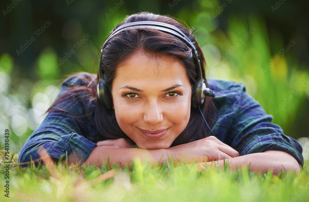 Grass, portrait and woman with headphones, park and streaming audio with peace, sound and sunshine. Person, outdoor and girl with headset, summer or podcast with radio, relaxing or listening to music Grass, portrait and woman with headphones, park and streaming audio with peace, sound and sunshine. Person, outdoor and girl with headset, summer or podcast with radio, relaxing or listening to music