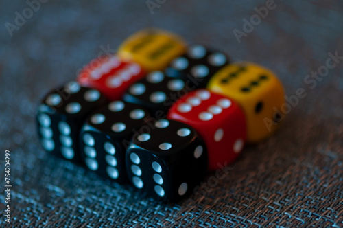 Close-up of colored dice sitting on a tablecloth photo