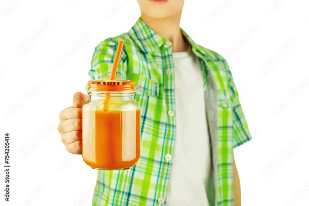 Isolated boy, teenager holding carrot juice or vegetable smoothie in a glass mug with straw on transparent background. Healthy food and drink for kid. Vegan or vegetarian diet