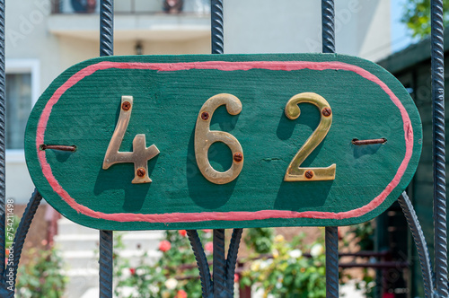 House number plate 462 on a metal gate. Street number. Address number.