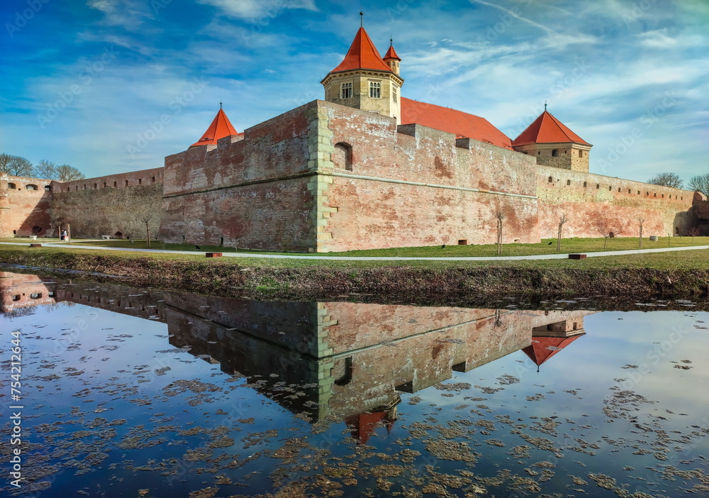 Water reflection with Fagaras Citadel Fortress in Brasov Romania