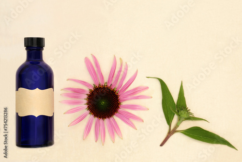 Echinacea herb for alternative medicine remedies with blue tincture bottle, flower head, leaf sprig on hemp paper background.