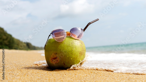 Fototapeta Naklejka Na Ścianę i Meble -  coconut cocktail on a sandy beach by the