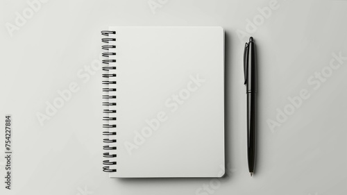 Blank open notebook with a sleek pen on a clean white background photo