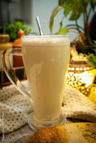 Glass of a iced coffee with cream milk. Cold brew coffee drink with ice. Early morning sun light. Copy space.