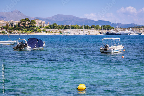 Boats on Garitsa Bay, Ionian Sea coast in Corfu town, Greece photo