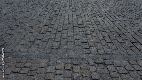 Close up cobblestone pavement, Granite cobblestoned pavement background. Stone pavement texture. Abstract background of cobblestone pavement close up. Seamless texture
