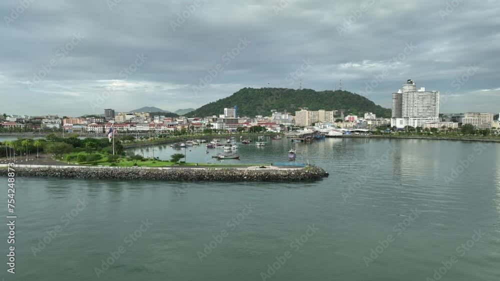 Drone shot that pans back from a promontory in Panama City, with a hill visible in the background. Drone shot that pans back from a promontory in Panama City, with a hill visible in the background.