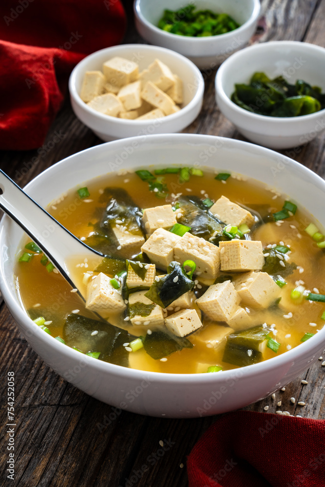 Miso soup - traditional Japanese soup with tofu on wooden table
Miso soup - traditional Japanese soup with tofu on wooden table