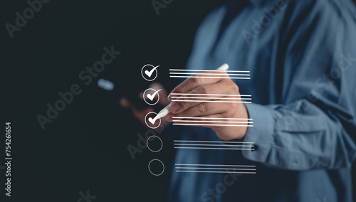 Digital Assessment Concept : Businessman Uses Mobile for Evaluation, Survey Exam, Survey Completion, and Checklist or Fills Assessment Survey for Performance Checklist.	
