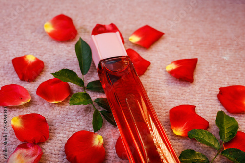 closup on Red Bottle with women perfume on rose petals