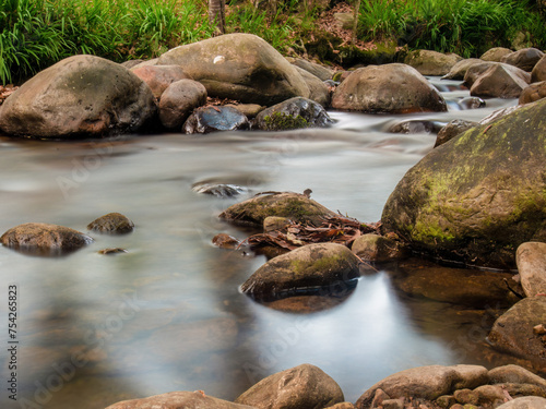 Long exposure shot of the stream and the rocks in the La Colorada creek, in the eastern Andean mountains of central Colombia. photo
