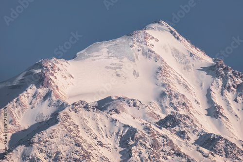 Beautiful rocky peak covered with snow and ice glacier, Sovetov Peak in the Alatau Tien Shan Range, Almaty Kazakhstan photo