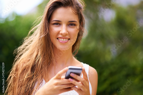 Cellphone, nature and portrait of woman in park networking on social media, app or internet. Serious, technology and young female person scroll on a phone for communication in outdoor field or garden