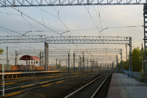 View of the railway and infrastructure and power lines at sunset