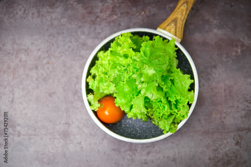 Lettuce leaves isolated on marbel background. Top view