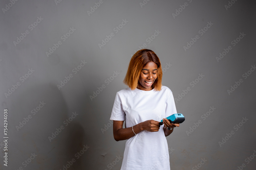 young excited lady doing thumps up while holding a pos machine young excited lady doing thumps up while holding a pos machine